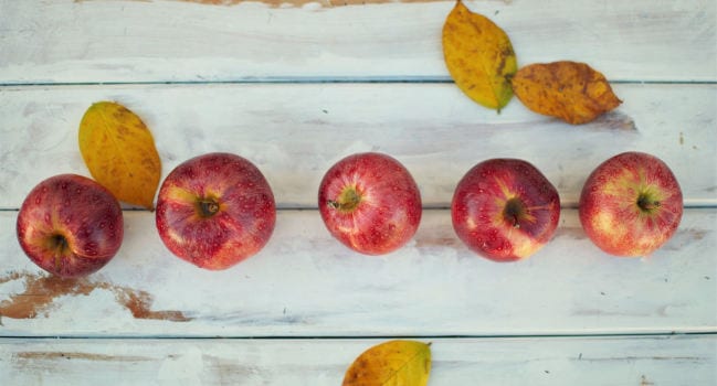 Apples sitting on picnic table